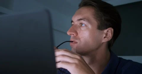 Close-up of pensive overworked businessman working late on laptop in evening Stock Footage 229846392