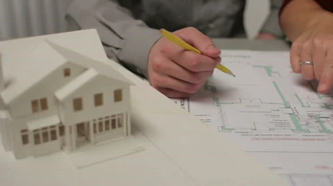 Close up of people going over architecture plans Stock Footage