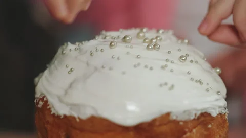 Close Up of the People Hands Decorating the Easter Cake. Glaze and Topping for Stock Footage 234143989