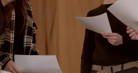 Close-up people with papers collaborating on a project, preparing a presentation Stock Footage 268089521