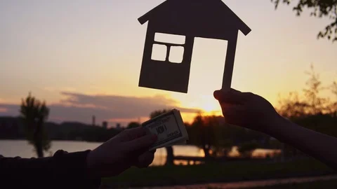 Close-up of people pass money on background of miniature house. 스톡 동영상 111016301