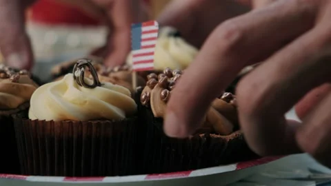 Close up of People picking up independence day cupcakes Video stock 133617049