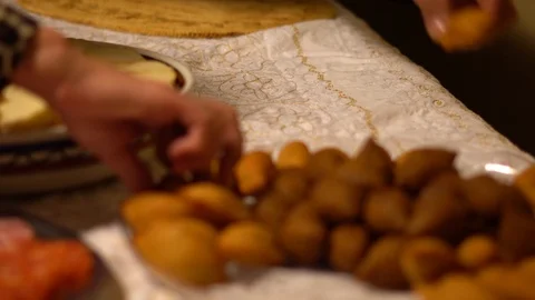 Close-up of people serving themselves appetizers at a festive gathering Stock Footage 97040122