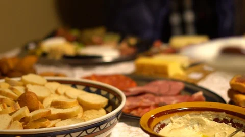 Close-up of people serving themselves appetizers at a festive gathering Stock Footage 97040196