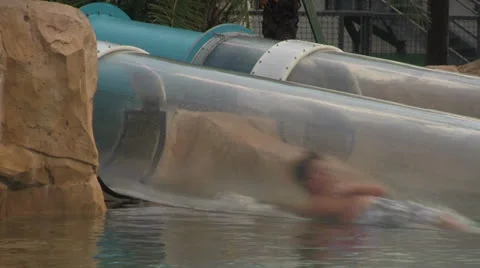 Close-up of People Sliding Down Submerged Water Tube Slide Stock Footage 25100330