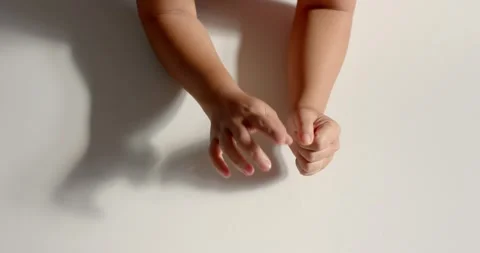 Close up of people talking to the camera, hands making shadow puppets on wall, Stock Footage 345567210