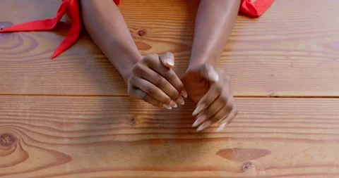 Close up of people talking to the camera, hands resting on wooden table, person Stock Footage 345570294