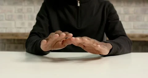 Close up of people talking to the camera, hands tapping on table, person in Stock Footage 346295819