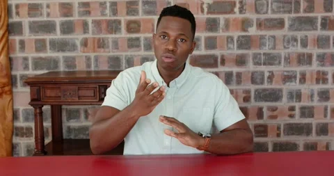 Close up of people talking to the camera, man sitting at red table, talking, Stock Footage 345567336