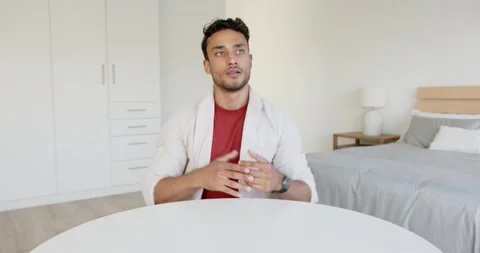 Close up of people talking to the camera, man sitting at table in bedroom, Stock Footage 345800014