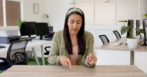 Close up of people talking to the camera, pointing at desk, woman in office with Stock Footage 345034284