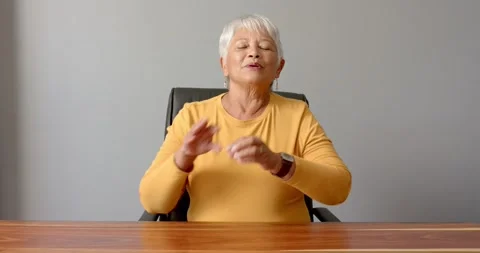 Close up of people talking to the camera, senior woman in yellow shirt sitting Stock Footage 346283449