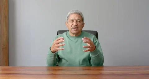 Close up of people talking to the camera, sitting at desk, elderly man gesturing Stock Footage 346026528