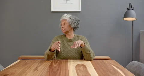 Close up of people talking to the camera, sitting at wooden table, elderly woman Stock Footage 346283787