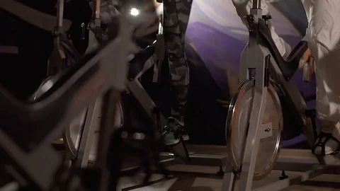Close-up of people training their legs on stationary bikes Stock-Footage 74143796