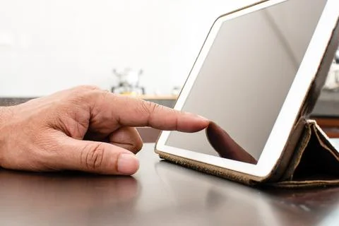 Close-Up, People using tablet search for food in the kitchen. A man with hi.. Stock Photos