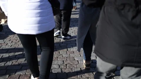 Close-up of people walking on the cobblestone pavement of Charles Bridge in Prag Stock Footage 293468744