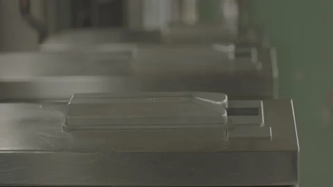 Close Up People Walking Through Turnstyle Swiping Card Stock Footage 135556345