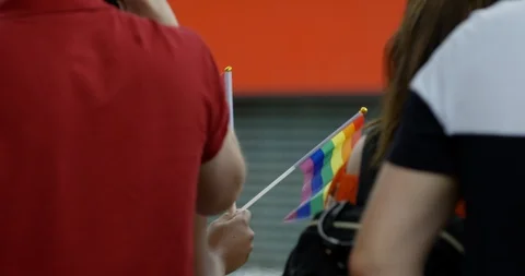 Close Up Of People Wave Colourful Rainbow Flags In Classic British City  Stock Footage 113515190