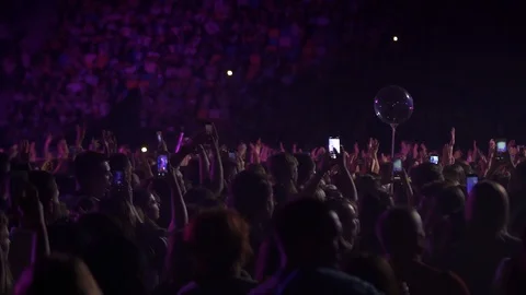 Close up people waving hands dance have fun in a live concert festival music Video stock 118473047