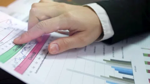 Close up of people working with Paperwork on a board room table at a business Vídeos de archivo 256739903