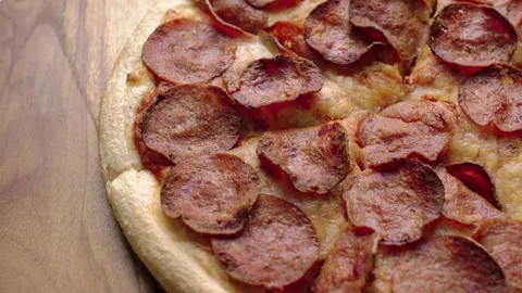 Close up of Pepperoni pizza spinning on table Video stock 309122447