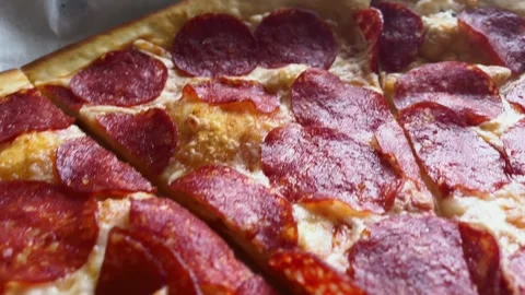 Close-up of pepperoni slices on melted cheese. Video footage of pizza texture. Stock Footage 333942811
