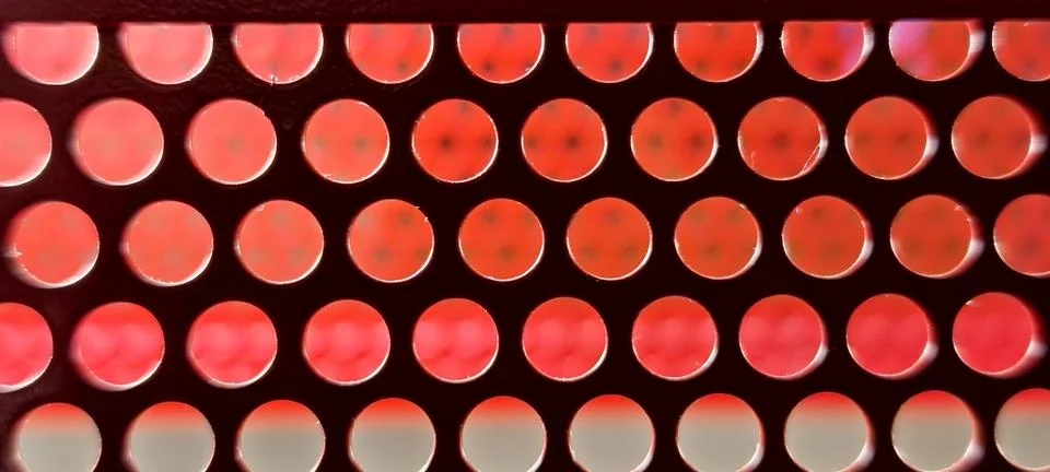 Close‑up of a perforated sheet with evenly spaced circular holes Foto stock