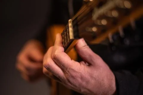 Close up performer plays classical mandolin on stage Stock Photos