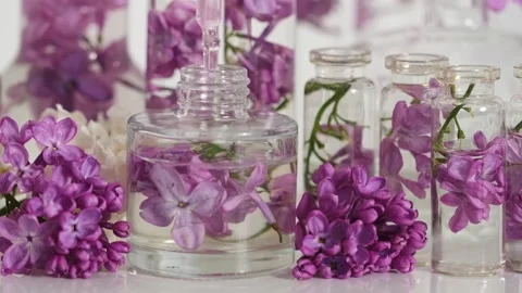Close-Up Perfume Bottle with Lilac Stock-Footage 331350457
