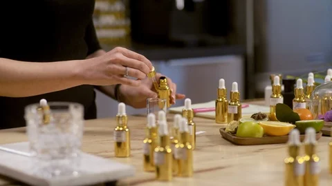 Close up of perfumer adding essential oil in beaker Stock Footage 105038128