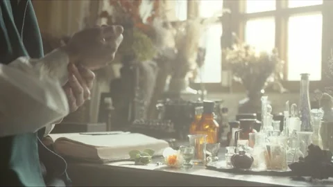 A close-up of a perfumer at his desk looking for a new fragrance. Vintage cin Vidéo 200275544
