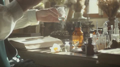 A close-up of a perfumer at his desk looking for a new fragrance. Vintage cin Stock Footage 200275832