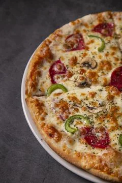 Close up of peroni pizza on a rustic background. portrait image Stock Photos
