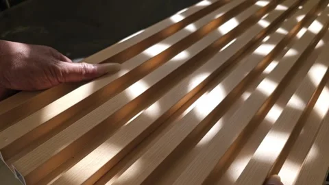 Close up of person assembling fluted wall panels joining WPC wood look panels Stock Footage 340001897