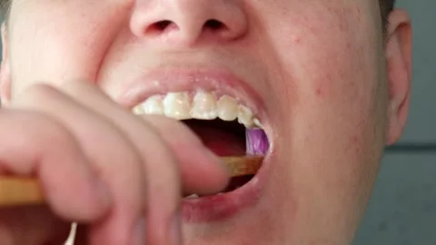Close-up of person brushing teeth with bamboo toothbrush. Stock Footage 306363704