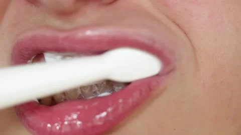 Close up of person brushing teeth with toothpaste and electric toothbrush Stock Footage 340261244