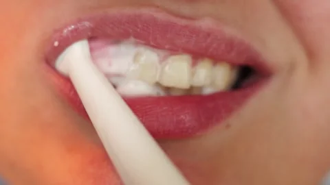 Close-up of a person brushing their teeth with toothpaste and foam Stock Footage 340261362