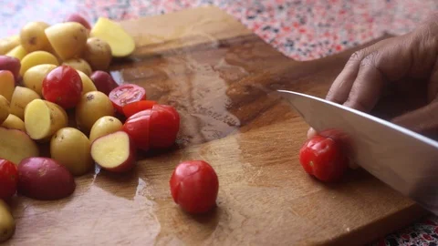 Close up of person chopping tomatoes to bake at home-8s Stock Footage 128661488