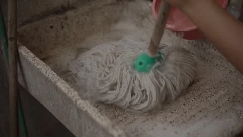 Close Up of Person Cleaning Stone Surface with Wet Mop During Manual Housework Stock-Footage 348148045