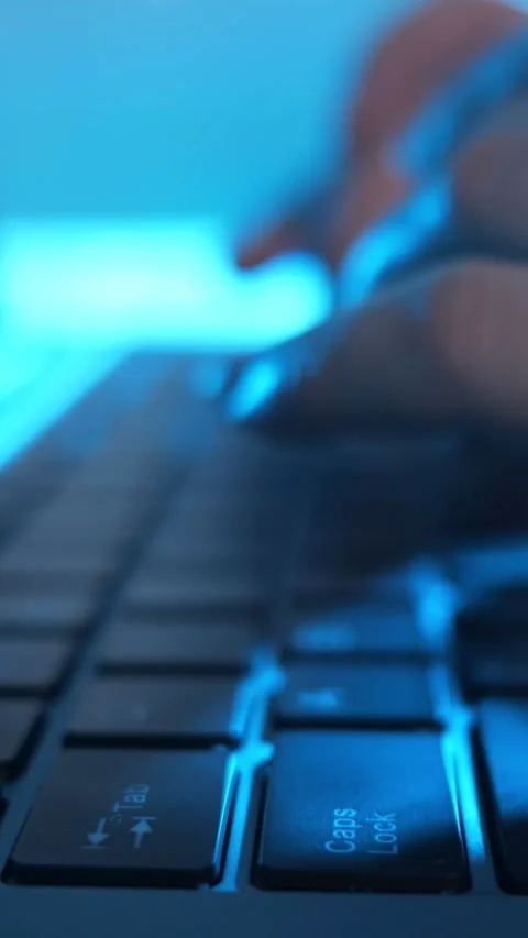 Close up of a person coding and typing on a laptop keyboard at night Stock Footage 342945170
