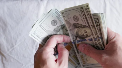 Close-up of person counting large stack of paper currency indoors Stock Footage 332122046