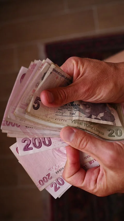 Close up of person counting multiple Turkish Lira paper bills, including 200 Stock Footage 344309792