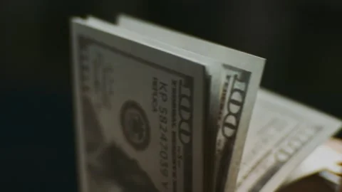Close up of person counting stack of hundred dollar bills with fingers for .. Stock Footage 337472047