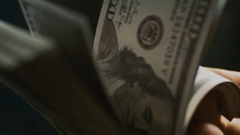 Close up of person counting stack of hundred dollar bills with fingers in c.. Stock Footage 337605887