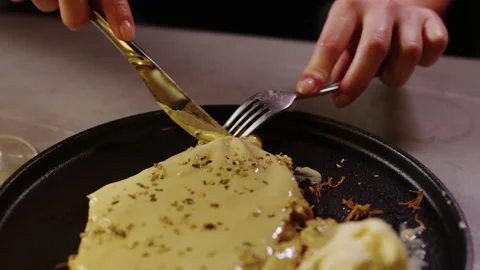Close Up of Person Cutting and Serving Creamy Dessert at Dining Table Stock Footage 342287236
