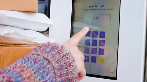 Close-up of a person entering a PIN on a touchscreen at a self-service parcel lo Stock Footage 337493386