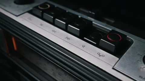 Close-Up of a Person Finger Pressing a Button on a Vintage Tape Player Stock Footage 334113503