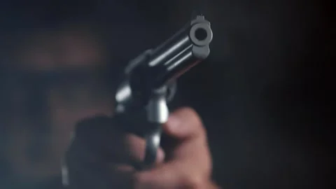 Close-up of Person Firing Gun with Muzzle Flash Stock Footage 257537802
