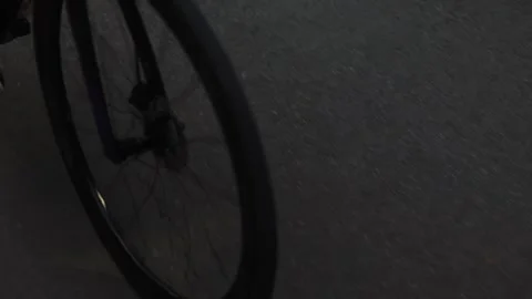 Close-up of a person in flip-flops riding a bicycle Stock Footage 338343985